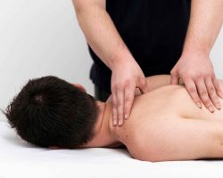 man-being-given-back-massage-by-physiotherapist