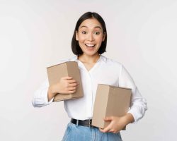 portrait-happy-korean-girl-holding-two-boxes-smiling-lookng-amazed-camera-concept-shopping-white-background